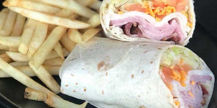 Delicious ham and cheese wrap with lettuce, tomato, fries and more at The Flagstone in Appleton WI.