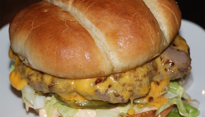 Flagstone cheeseburger with lettuce